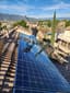 Solar panels being cleaned by a tech.